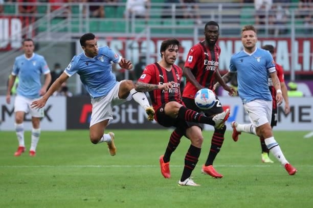 Pedro of SS Lazio competes for the ball with Sandro Tonali of AC Milan during the Serie A match between AC Milan and SS Lazio at Stadio Giuseppe...