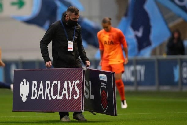 Grounsmen clear the Barclays FA WSL branding from the pitch during the Barclays FA Women's Super League match between Manchester City Women and...