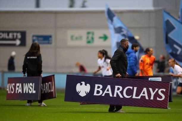 Grounsmen clear the Barclays FA WSL branding from the pitch during the Barclays FA Women's Super League match between Manchester City Women and...