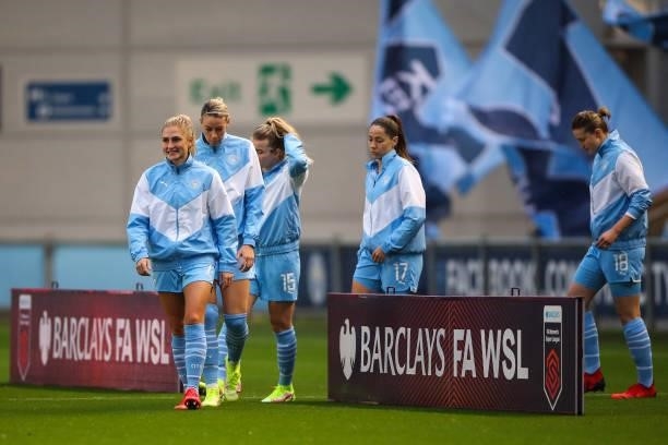 Players of Manchester City Women walk out past Barclays FA WSL branding during the Barclays FA Women's Super League match between Manchester City...
