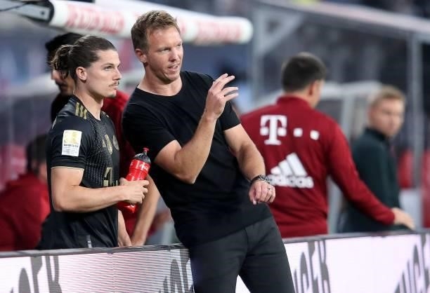 Bayern Munich's head coach Julian Nagelsmann speaks to Bayern Munich's Austrian midfielder Marcel Sabitzer during the German first division...
