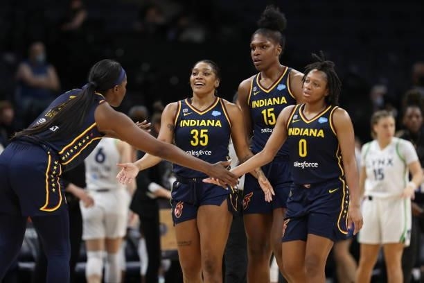 Victoria Vivians, Teaira McCowan and Kelsey Mitchell of the Indiana Fever celebrate during the game against the Minnesota Lynx on September 12, 2021...