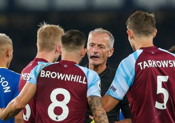 Referee Martin Atkinson is surrounded by Burnley players during the Premier League match between Everton and Burnley at Goodison Park on September...