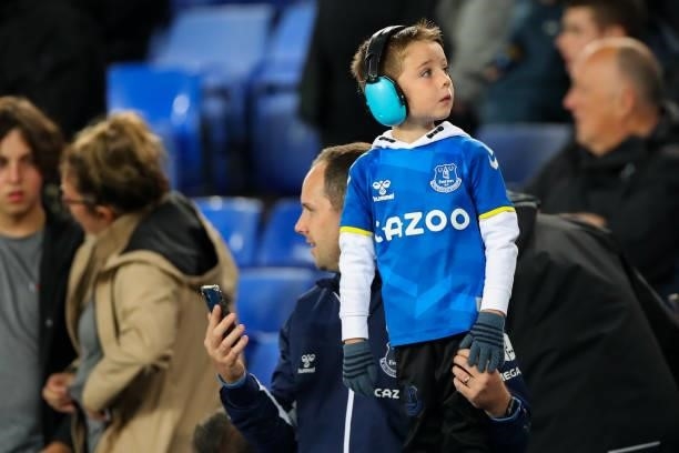 Young fan of Everton wearing ear protection during the Premier League match between Everton and Burnley at Goodison Park on September 13, 2021 in...