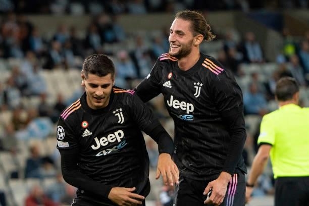 Alvaro Morata of Juventus FC celebrates after scoring his team's third goal with teammates during the UEFA Champions League group H match between...