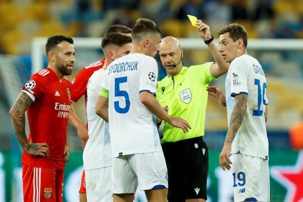 Referee Anthony Taylor shows Denys Garmash of Dinamo Kiev the yellow card during the UEFA Champions League Group E match between Dinamo Kiev and SL...