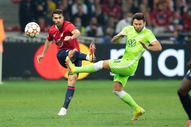 Zeki Celik of Lille OSC and Renato Steffen of VfL Wolfsburg battle for the ball during the UEFA Champions League group G match between Lille OSC and...
