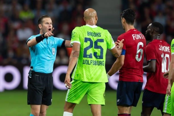 Referee Danny Makkelie, John Anthony Brooks of VfL Wolfsburg, Jose Fonte of Lille OSC and Jonathan Ikone of Lille OSC discusses during the UEFA...