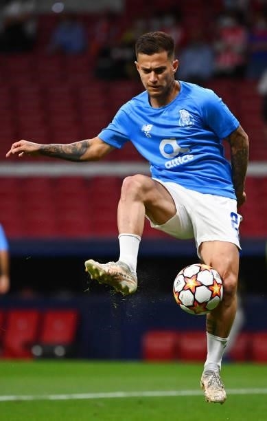 Porto's Brazilian midfielder Otavio warms up before the UEFA Champions League first round group B football match between Atletico Madrid and Porto at...