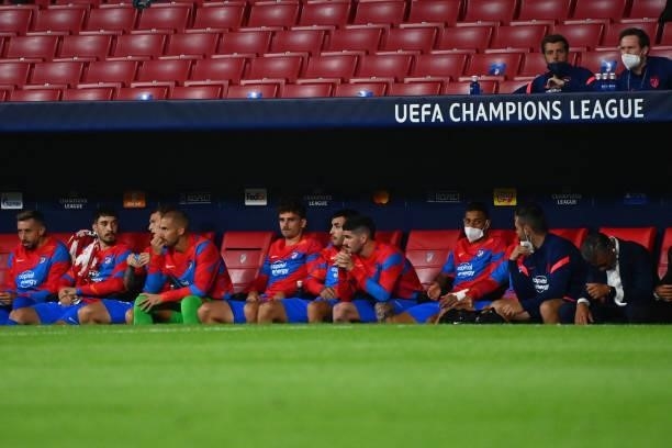 Atletico's substitute players sit on the bench during the UEFA Champions League first round group B football match between Atletico Madrid and Porto...