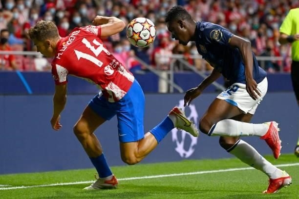 Atletico Madrid's Spanish midfielder Marcos Llorente vies with FC Porto's Nigerian defender Zaidu Sanusi during the UEFA Champions League first round...