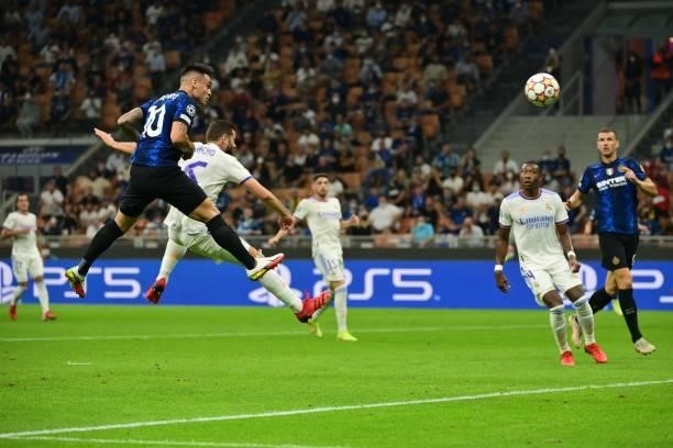 Inter Milan's Argentine forward Lautaro Martinez shoots a header during the UEFA Champions League Group D football match between Inter Milan and Real...