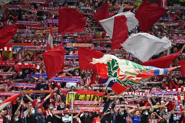 Atletico fans hold up their scarves during the UEFA Champions League first round group B football match between Atletico Madrid and Porto at the...