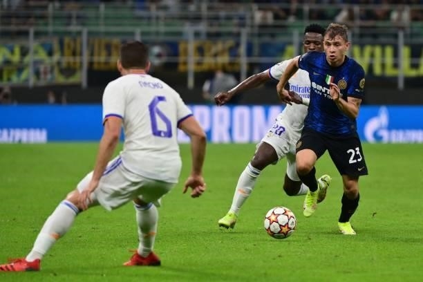 Inter Milan's Italian midfielder Nicolo Barella outruns Real Madrid's Brazilian forward Vinicius Junior during the UEFA Champions League Group D...