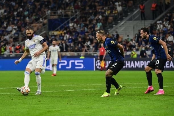 Real Madrid's French forward Karim Benzema challenges Inter Milan's Italian defender Federico Dimarco and Inter Milan's Turkish midfielder Hakan...