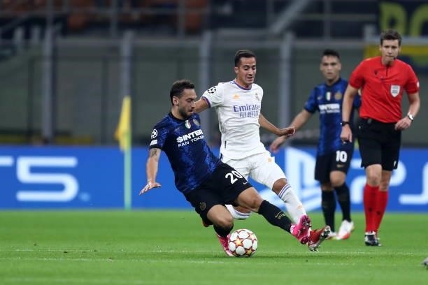 Hakan Calhanoglu of FC Internazionale and Lucas Vazquez of Real Madrid CF battle for the ball during the UEFA Champions League group D match between...