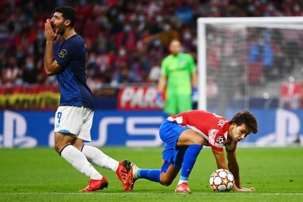 Porto's Iranian forward Mehdi Taremi reacts to being fouled by Atletico Madrid's Portuguese midfielder Joao Felix during the UEFA Champions League...