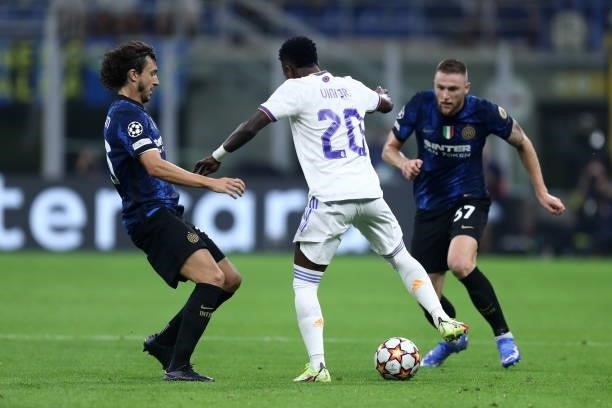 Vinicius Junior of Real Madrid CF and Matteo Darmian of FC Internazionale battle for the ball during the UEFA Champions League group D match between...