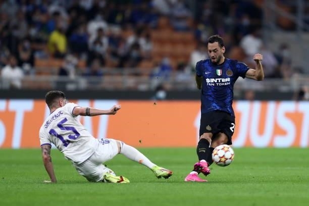 Hakan Calhanoglu of FC Internazionale and Federico Valverde of Real Madrid CF battle for the ball during the UEFA Champions League group D match...