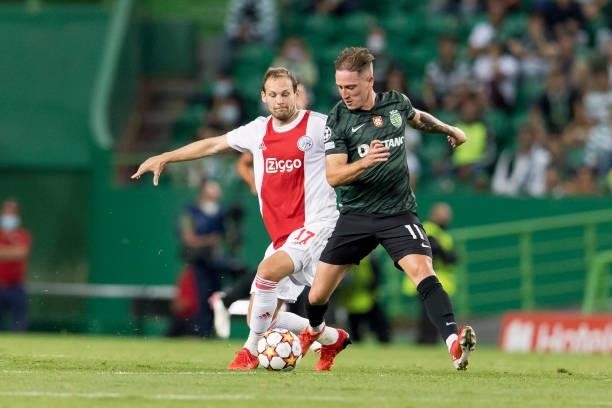 Daley Blind of Ajax Amsterdam and Nuno Santos of Sporting CP battle for the ball during the UEFA Champions League group C match between Sporting CP...