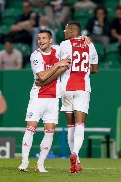 Sebastian Haller of Ajax Amsterdam celebrates after scoring his team's fourth goal with teammates during the UEFA Champions League group C match...