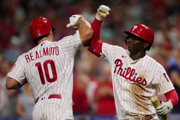 Realmuto of the Philadelphia Phillies celebrates with Didi Gregorius after hitting a solo home run in bottom of the eighth inning during the game...