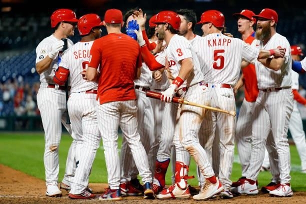 Andrew Knapp of the Philadelphia Phillies celebrates with teammates after scoring the game winning run in the bottom of the ninth as the Phillies...