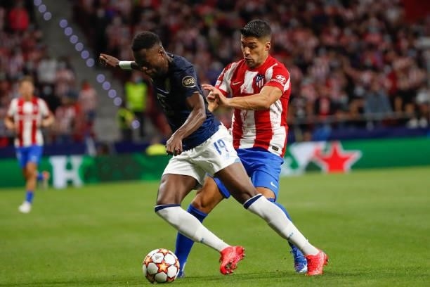 Luis Suarez of Atletico de Madrid in action with Mbemba of FC Porto during the UEFA Champions League match between Atletico de Madrid and FC Porto at...