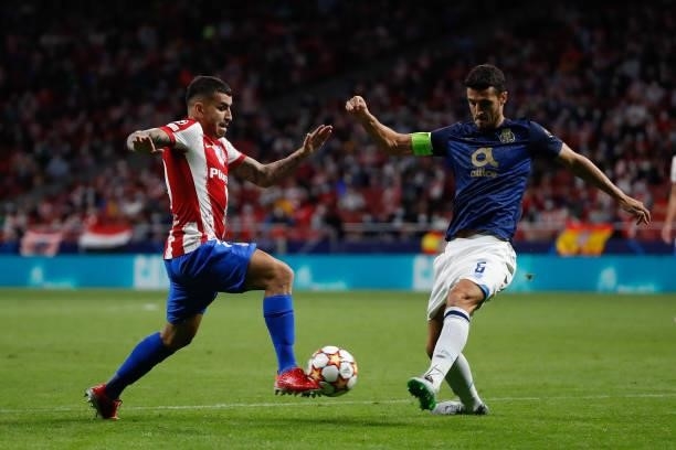 Angel Correa of Atletico de Madrid in action with Ivan Marcano of FC Porto during the UEFA Champions League match between Atletico de Madrid and FC...