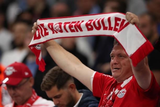 Fan of RB Leipzig holds up a scarf during the UEFA Champions League group A match between Manchester City and RB Leipzig at Etihad Stadium on...