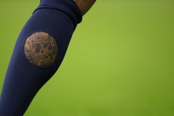 Tattoo on the leg of Angelino of RB Leipzig is seen through a hole in a sock during the UEFA Champions League group A match between Manchester City...