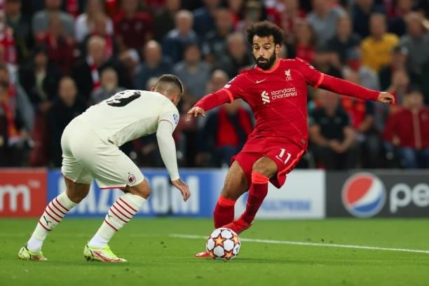 Mohamed Salah of Liverpool FC and Theo Hernandez of Milan battle for the ball during the UEFA Champions League group B match between Liverpool FC and...