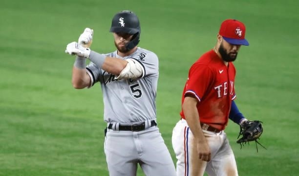 Romy Gonzalez of the Chicago White Sox reacts after hitting a double as Isiah Kiner-Falefa of the Texas Rangers looks on during the fourth inning at...