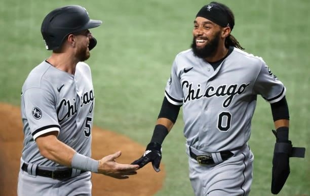Romy Gonzalez of the Chicago White Sox and teammate Billy Hamilton celebrate after scoring runs against the Texas Rangers during the fourth inning at...