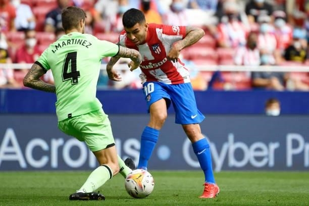 Athletic Bilbao's Spanish defender Inigo Martinez vies with Atletico Madrid's Argentine forward Angel Correa during the Spanish League football match...
