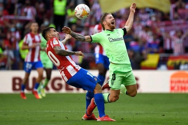 Atletico Madrid's Argentine forward Angel Correa fouls Athletic Bilbao's Spanish forward Iker Muniain during the Spanish League football match...