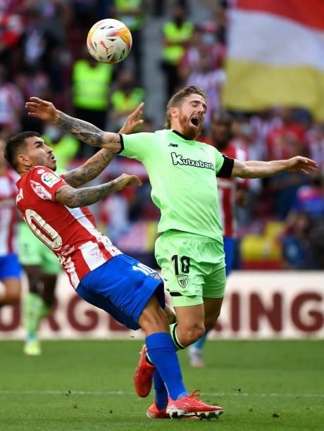 Atletico Madrid's Argentine forward Angel Correa fouls Athletic Bilbao's Spanish forward Iker Muniain during the Spanish League football match...