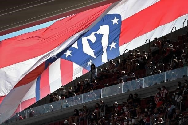 Atletico Madrid flag flies outside the stadium while spectators watch the Spanish League football match between Club Atletico de Madrid and Athletic...