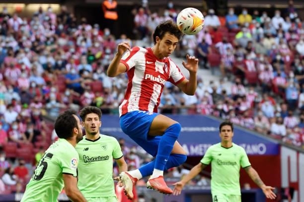 Atletico Madrid's Portuguese midfielder Joao Felix heads the ball during the Spanish League football match between Club Atletico de Madrid and...