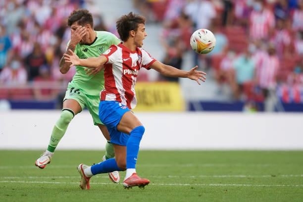 Joao Felix of Atletico Madrid and Unai Vencedor of Athletic compete for the ball during the La Liga Santander match between Club Atletico de Madrid...