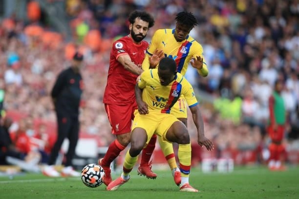 Mohamed Salah of Liverpool battles with Wilfried Zaha of Crystal Palace and Tyrick Mitchell of Crystal Palace during the Premier League match between...