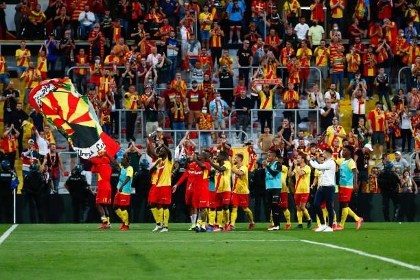The players of RC Lens celebrate with the fans the victory of the Ligue 1 Uber Eats match between Lens and Lille at Stade Bollaert-Delelis on...