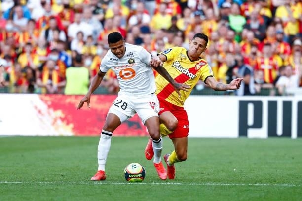 Florian Sotoca of RC Lens challenges Reinildo Mandava of Lille OSC during the Ligue 1 Uber Eats match between Lens and Lille at Stade...