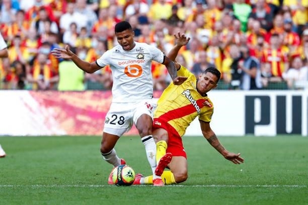 Florian Sotoca of RC Lens challenges Reinildo Mandava of Lille OSC during the Ligue 1 Uber Eats match between Lens and Lille at Stade...