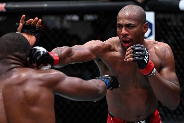 In this handout photo provided by UFC, Mike Rodriguez punches Tafon Nchukwi of Cameroon in a light heavyweight fight during the UFC Fight Night event...