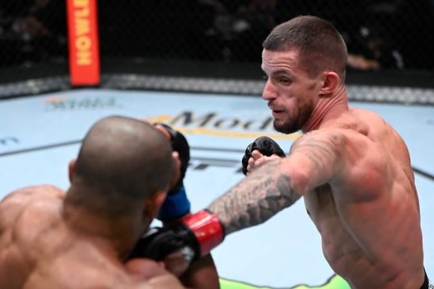 In this handout photo provided by UFC, Nate Maness punches Tony Gravely in a bantamweight fight during the UFC Fight Night event at UFC APEX on...