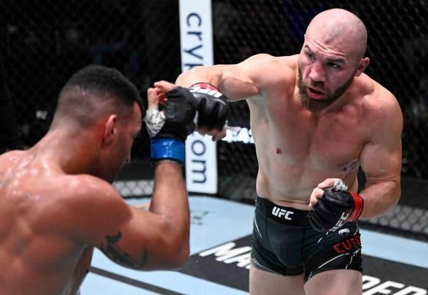 In this handout photo provided by UFC, Ion Cutelaba of Moldova punches Devin Clark in a light heavyweight fight during the UFC Fight Night event at...