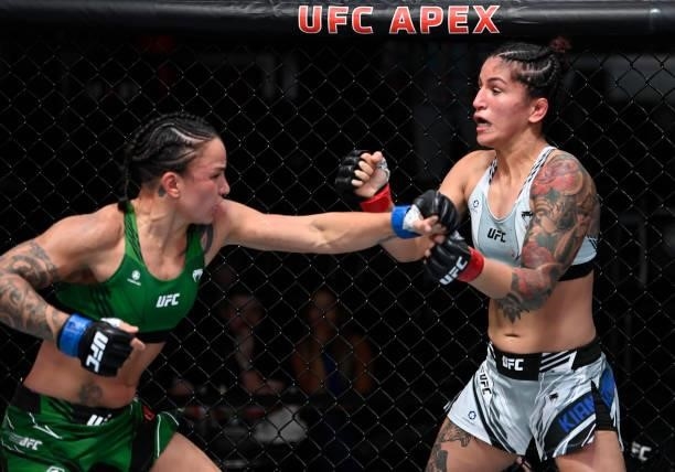 In this handout photo provided by UFC, Raquel Pennington punches Pannie Kianzad of Iran in a bantamweight fight during the UFC Fight Night event at...