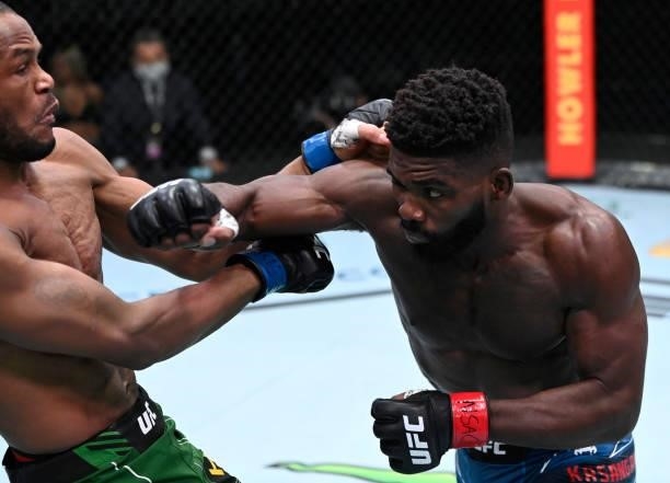 In this handout photo provided by UFC, Impa Kasanganay punches Carlston Harris of Guyana in a welterweight fight during the UFC Fight Night event at...