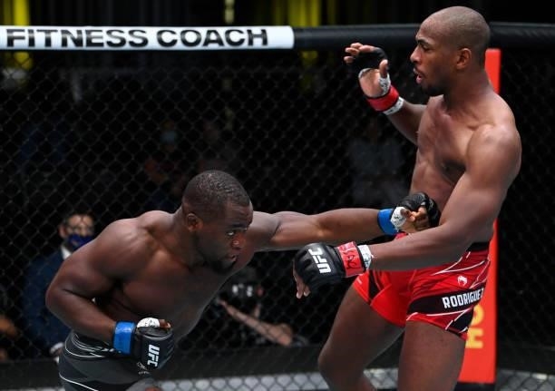 In this handout photo provided by UFC, Tafon Nchukwi of Cameroon punches Mike Rodriguez in a light heavyweight fight during the UFC Fight Night event...